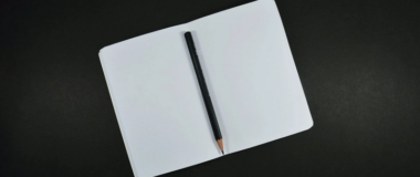 an open book and pencil